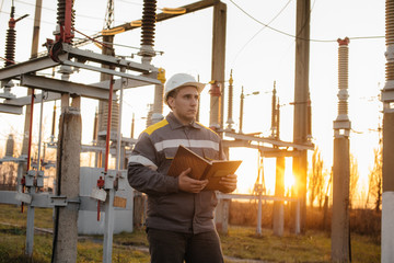 The energy engineer inspects the equipment of the substation. Power engineering. Industry