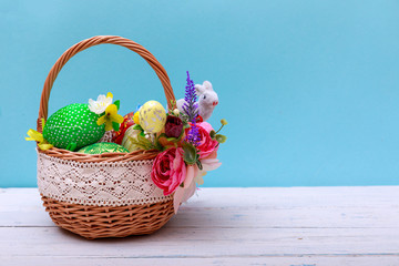 Easter eggs basket in a green grass garden. With copy space for your greetings