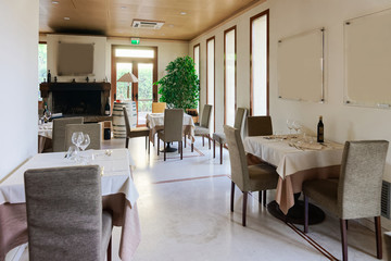 Fototapeta na wymiar Retro restaurant interior wine shelves and tables chairs