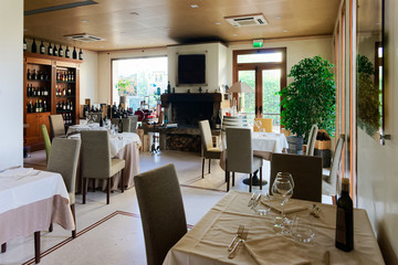 Fototapeta na wymiar Retro restaurant interior with wine shelves tables with chair