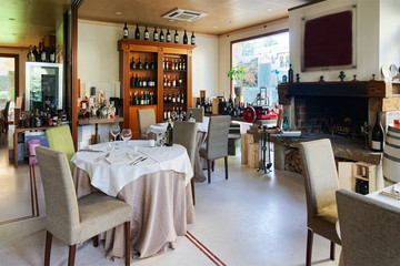 Retro restaurant interior with wine shelves tables with chairs