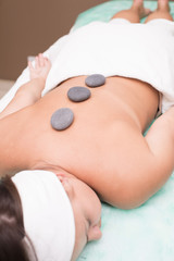 Portrait of a young woman blissfully enjoying spa therapy. close-up. Massage stones