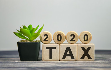 Text - tax 2020 on wooden cubes, on wooden background