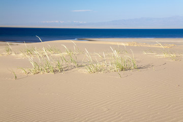 Gobi Desert Singing Sand Dunes lake at background