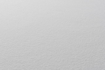 Winter background with a copy of the space , smooth texture of white snow.