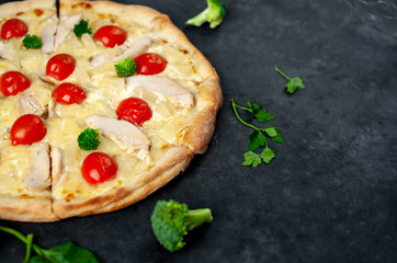delicious pizza with pineapple, broccoli, tomatoes, mozzarella cheese, chicken fillet on a stone background with copy space for your text