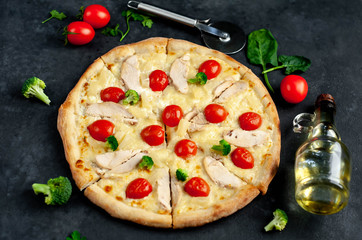 delicious pizza with pineapple, broccoli, tomatoes, mozzarella cheese, chicken fillet on a stone background