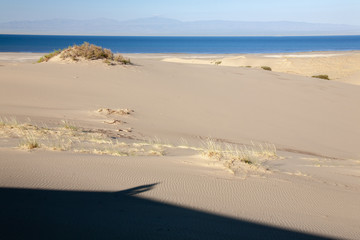 Gobi Desert Singing Sand Dunes lake at background