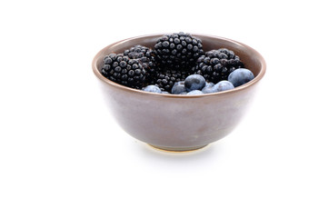 Blueberry and Blackberry on blown cup with white background, fruit concept