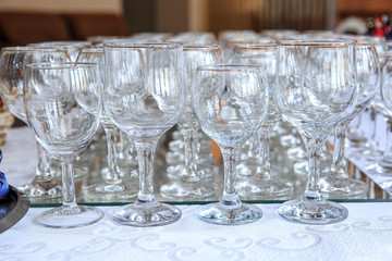 Glass goblets on the table in front of the buffet table. Foreground sharpness