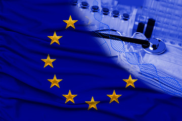 medical tubes, stethoscope in the corner of the silk national flag of the European Union State, medicine concept, coronavirus, SARS, COVID-19