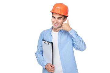 Cheerful builder in helmet shows 