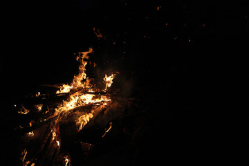 Bonfire in front of a lake at night