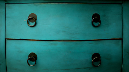 Old blue chest of drawers in the studio, shelves, side view, cropped image, close up