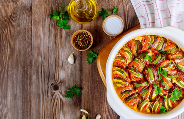 Vegetable ratatouille baked in white oven pan. French dish.