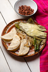 Mexican grilled nopal cactus with quesadillas and serrano chili peppers on white background