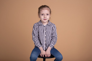 little girl isolated on beige neutral background