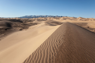 Fototapeta na wymiar Gobi Desert Singing Sand Dunes mountain at background