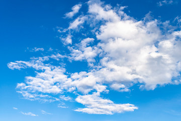 Fototapeta premium Bright blue azure sky with white cirrus clouds in a clean atmosphere. Beautiful sky background with snow white cloud.