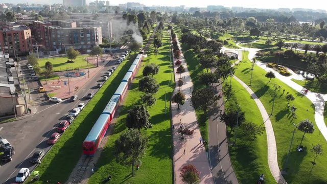Sabana Train passing trough park in Bogota