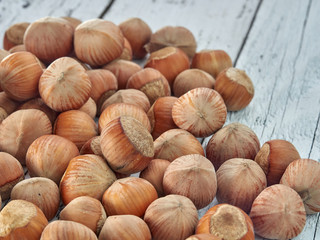 Hazelnuts lie on light wooden boards.Useful hazelnut for health.
