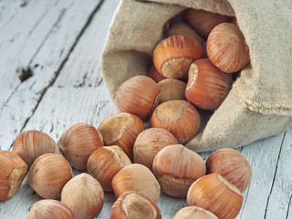 Hazelnuts lie on light wooden boards.Useful hazelnut for health.