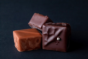 Composition of natural chocolate on a dark background.