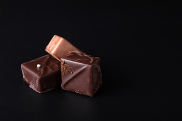 Composition of natural chocolate on a dark background.