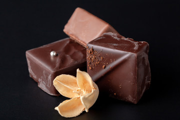 Composition of natural chocolate on a dark background.