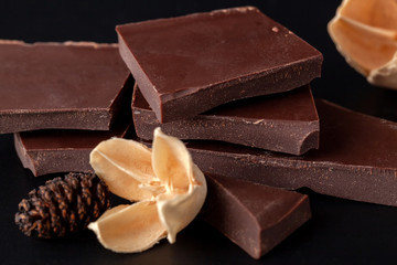Composition of natural chocolate on a dark background.