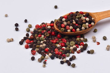 A mixture of red, black, green and white pepper