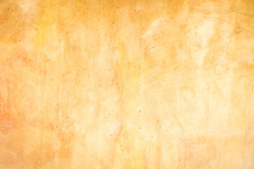 Orange Plastered Walls With Damages. Empty Brickwall With Uneven Surface. A Time Shattered Plaster. Layers Of Building Materials, Plaster, Cement, Whitewash and Bricks.