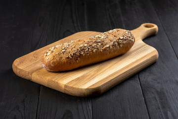 a loaf of bread on a wooden board