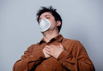 guy in the mask has a heartache, on a gray background
