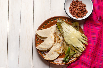 Mexican grilled nopal cactus with quesadillas and serrano chili peppers on white background