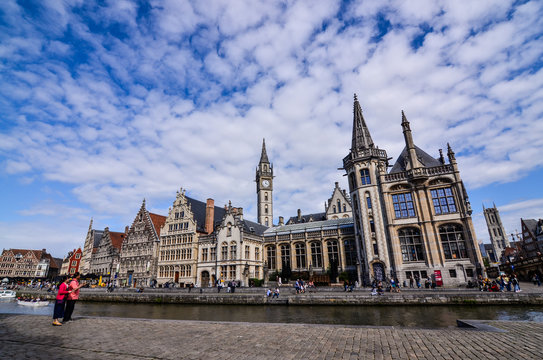 Ghent, Belgium, August 2019. Breathtaking cityscape: from the St. Michael bridge along the Graslei canal. One of the most beautiful postcards in the city. On the left a couple stopped to admire.