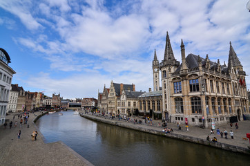 Ghent, Belgium, August 2019. Breathtaking cityscape: from the St. Michael's bridge to the street along the Graslei canal. One of the most beautiful postcards in the city. People stop to watch.