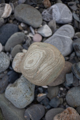 Texture pebbles. Large stones. Beautiful background. Coast. Beautiful gray beach.