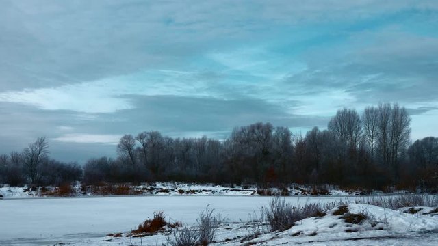 Panorama Evening Winter Landscape. Moving Along Rural Road in Plains. Cloudy Sky Above Snow Covered Field And River. Cold Weather on Winter Holidays