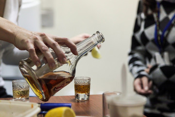 A company of young people drink alcohol.