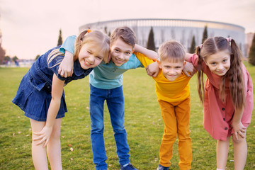 Happy children play and relax in the summer park.