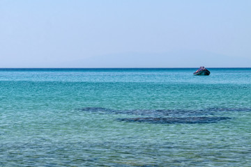 Halkidiki, Greece - September 04,2019: A beautiful Greek beach on the Aegean Sea in Halkidiki. Black sea urchin in the sea 