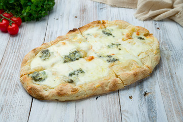 Roman pizza four cheeses on Roman dough, pinsa