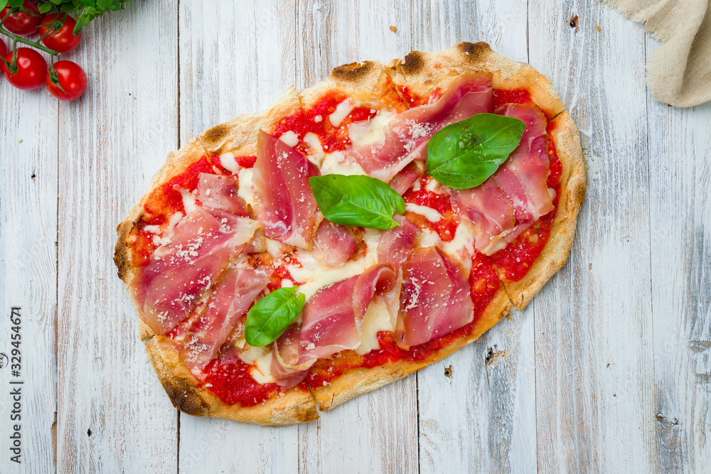 Wall mural Pinsa with parma ham rome pizza on white wooden board