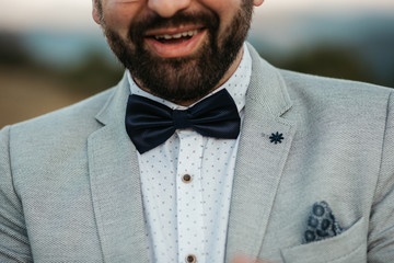 Beautiful elegant groom in wedding suit with long sleeves. Handsome man in tux. Portrait of man...