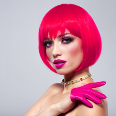 Model with creative colored bob hairstyle. Girl in leather gloves. Beautiful young fashion woman...