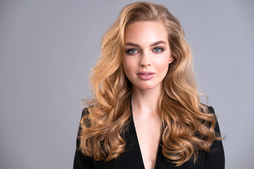 Beautiful face of an attractive model with blue eyes. Woman with beauty long brown hair and natural...