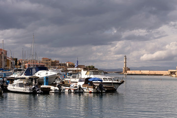 Fototapeta premium View of moored boats, yachts and ancient lighthouse (island Crete, Greece)