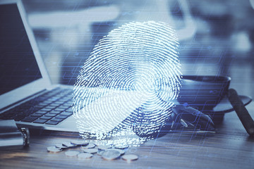 Computer on desktop in office with finger print drawing. Double exposure. Concept of business data security.