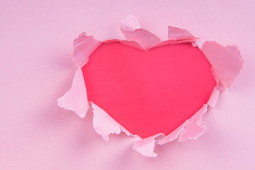 Naklejka na ściany i meble Torn paper red heart on a pink background